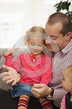 Father with small daughters photo