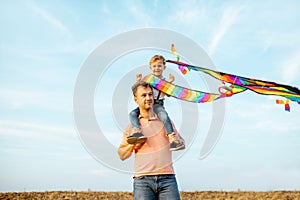 Father and son with air kite outdoors