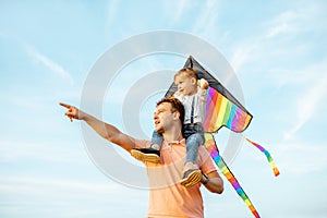 Father and son with air kite outdoors