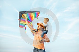 Father and son with air kite outdoors