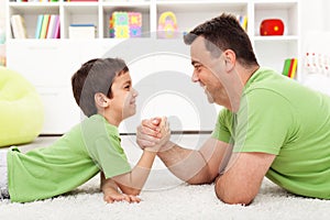 Father and son arm wrestling