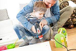 Father and son assembling furniture