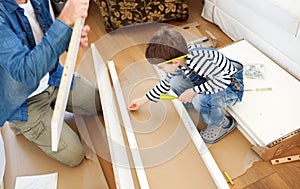 Father and son assembling furniture