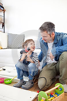 Father and son assembling furniture