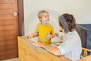 Father and son assembling furniture. Boy helping his dad at home. Happy Family concept