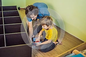 Father and son assembling furniture. Boy helping his dad at home. Happy Family concept