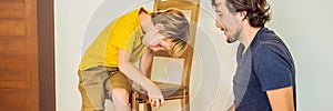 Father and son assembling furniture. Boy helping his dad at home. Happy Family concept BANNER, LONG FORMAT