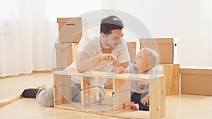 Father and son assembling furniture at home