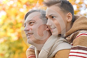 Father and son in autumn park