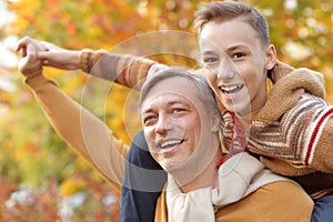 Father and son in autumn park