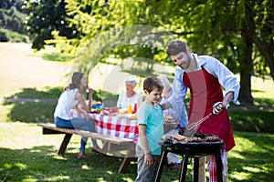 Father and son barbequing in the park