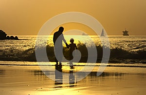 Father and son in the beach