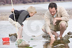 Father and son at beach fishing