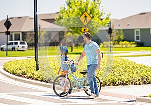 father and son on bicycle at fathers day. active father setting a example for fathers son. fathers parenting with son