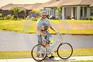 father and son on bicycle at fathers day. active father setting a example for fathers son. fathers parenting with son