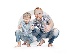 Father with son in blue tattered jeans with great gesture