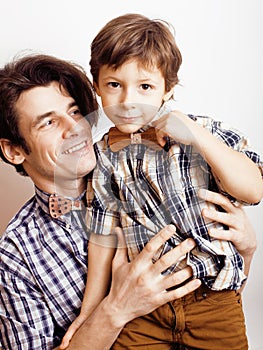 Father with son in bowties on white background