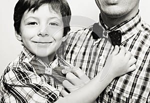 Father with son in bowties on white background,