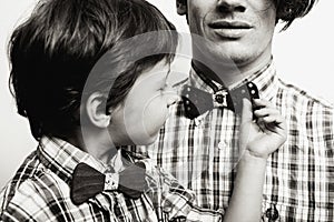 Father with son in bowties on white background