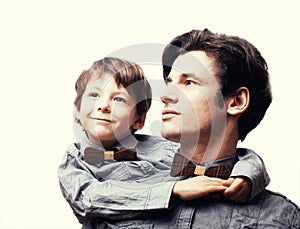 Father with son in bowties on white background