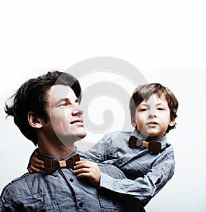 Father with son in bowties on white background, casual look