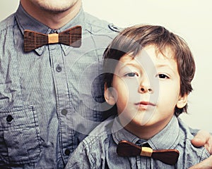 Father with son in bowties on white background, casual look