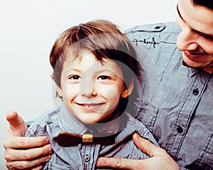 Father with son in bowties on white background, casual look