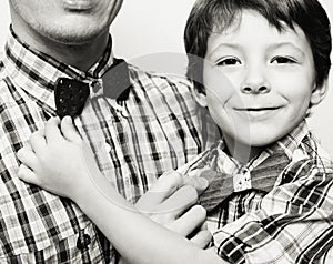 Father with son in bowties on white background, casual look family