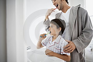 Father And Son Brushing Teeth