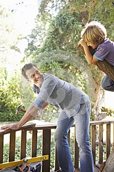 Father And Son Building Tree House Together