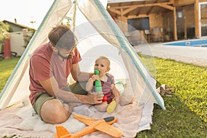 Father and son camping in the backyard