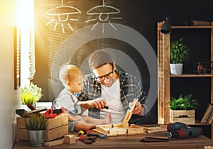 Father and son carved of wood in carpentry workshop