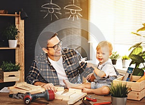 Father and son carved of wood in carpentry workshop