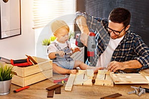 Father and son carved of wood in carpentry workshop