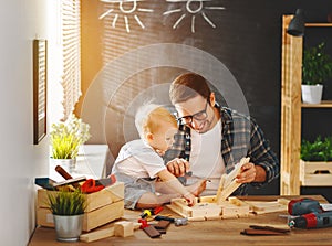 Father and son carved of wood in carpentry workshop