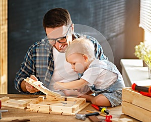 Father and son carved of wood in carpentry workshop