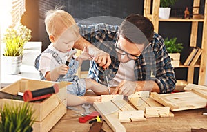 Father and son carved of wood in carpentry workshop