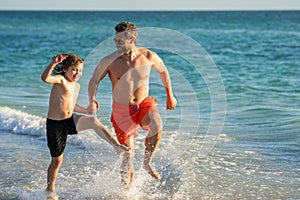 Father son child bonding enjoying summer vacation. Special moments between daddy and son at sea. Father son kid bonding