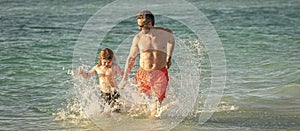 Father son child bonding enjoying summer vacation. Special moments between daddy and son at sea. Father son kid bonding