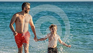 Father son child bonding enjoying summer vacation. Special moments between daddy and son at sea. Father son kid bonding