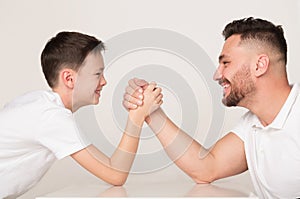 Father and son compete in arm wrestling