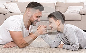 Father and son compete in armwrestling at home