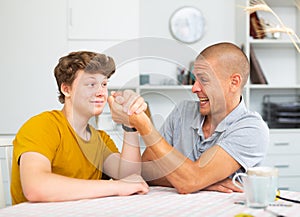 Father and son competing in arm wrestling
