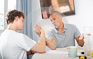 Father and son competing in arm wrestling