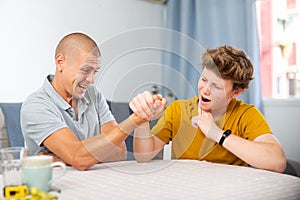 Father and son competing in arm wrestling