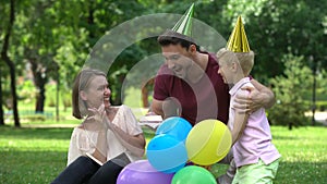 Father and son congratulate mom on birthday, pleasant surprise from parents