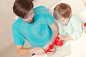 Father and son cook pepper