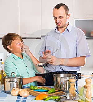 Father and son cooking dinner