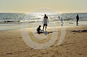 Father and son on the Costa Ballena beach, Cadiz province, Spain photo