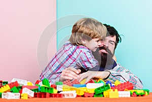 Father and son create constructions. Bearded man and son play together. Surefire ways to bond with your son. Father son photo